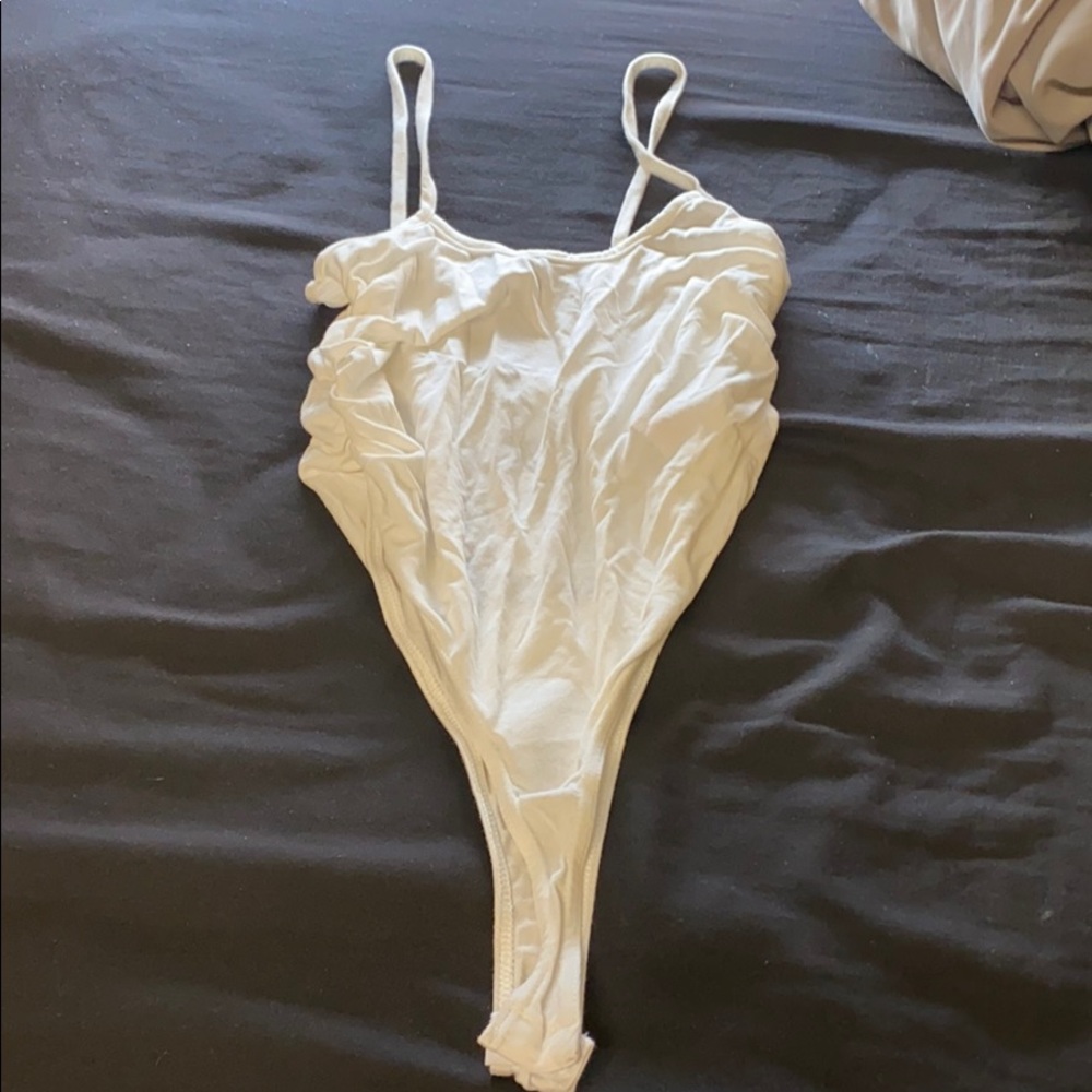 Scrunched at the side body suit.